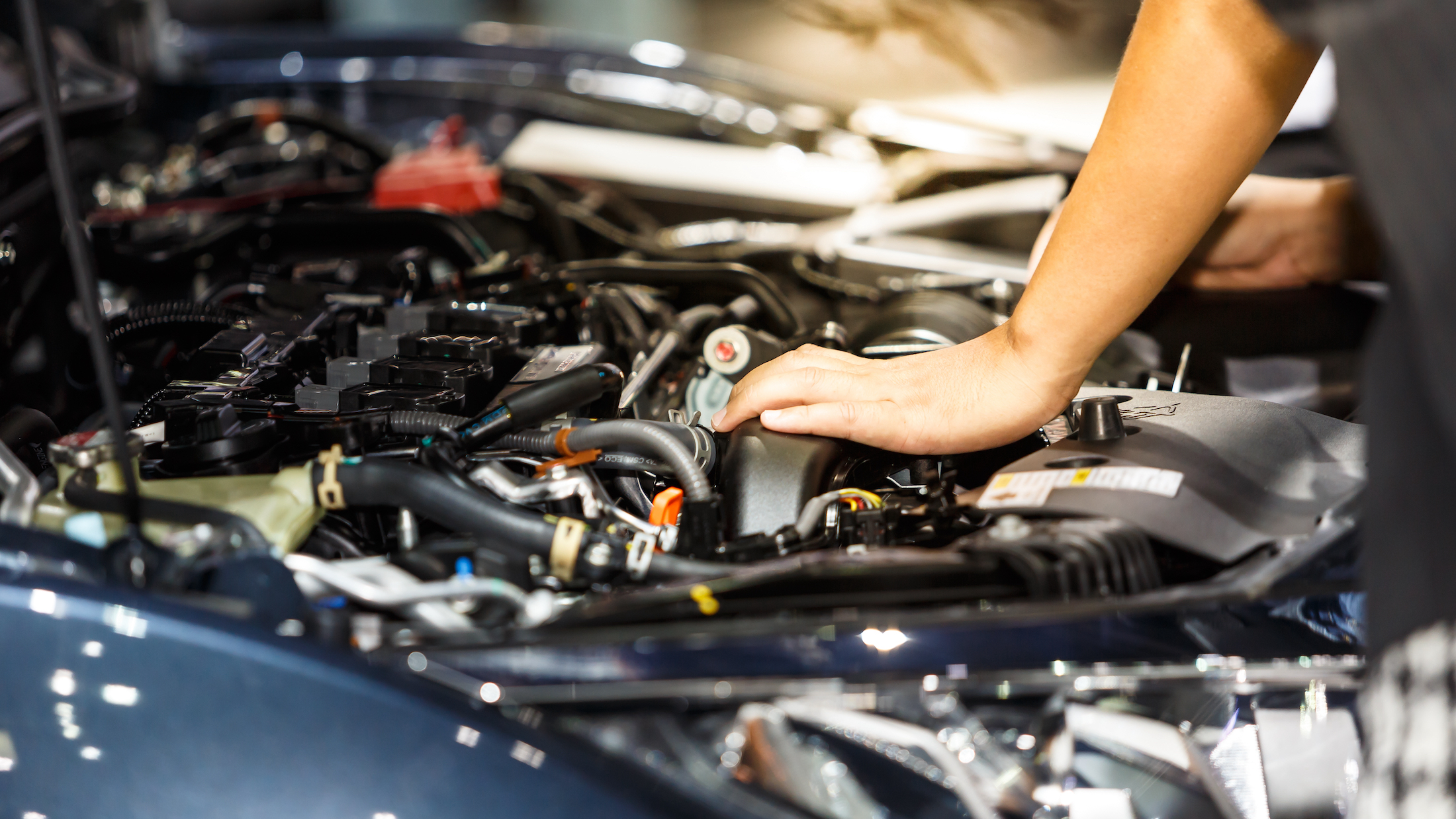 Hand of auto mechanic with a wrench